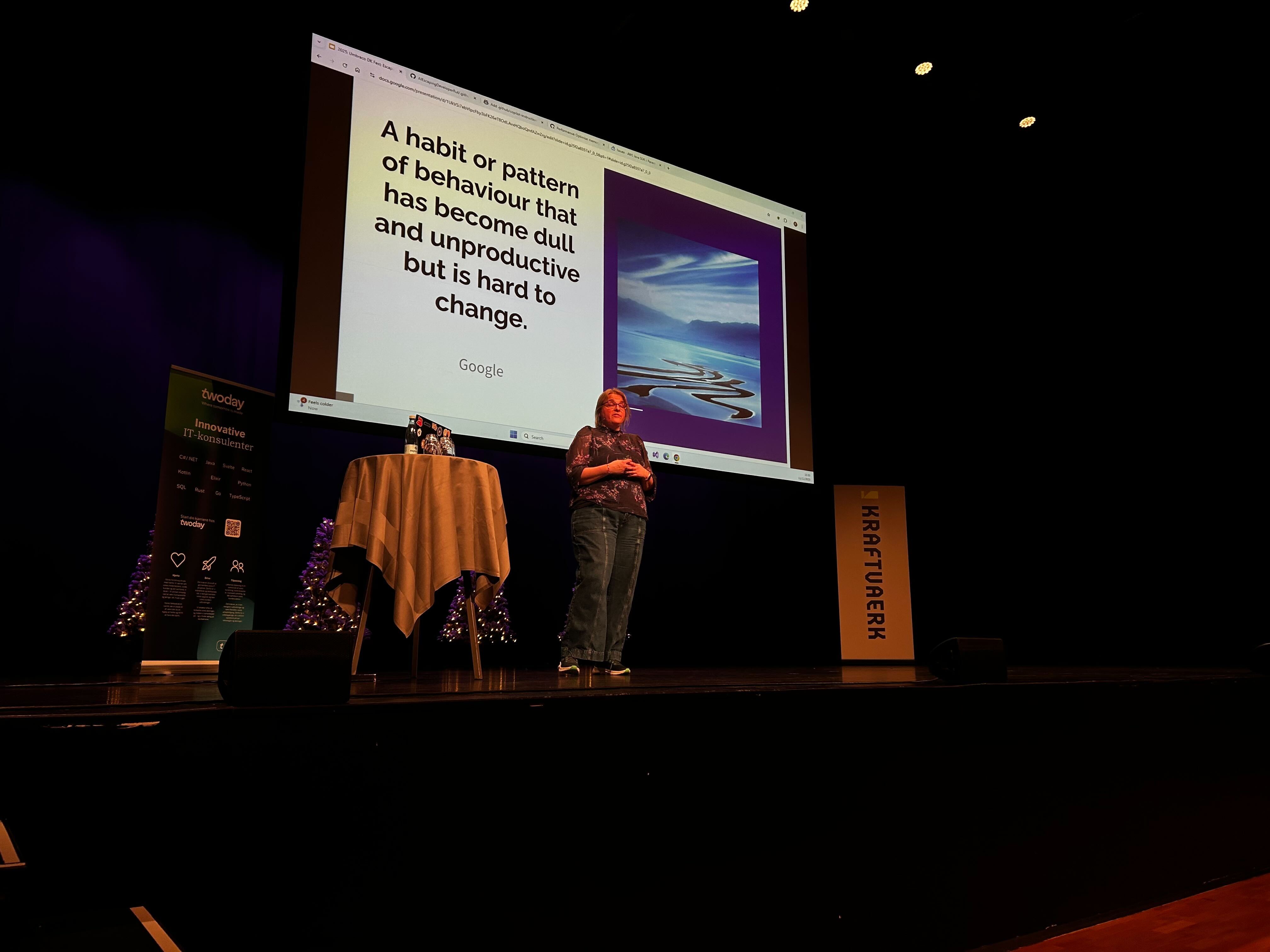 Rachel On Stage At DK Fest, stood of a slide defining a rut as "A habit or pattern of behaviour that has become dull and unproductive but is hard to change"