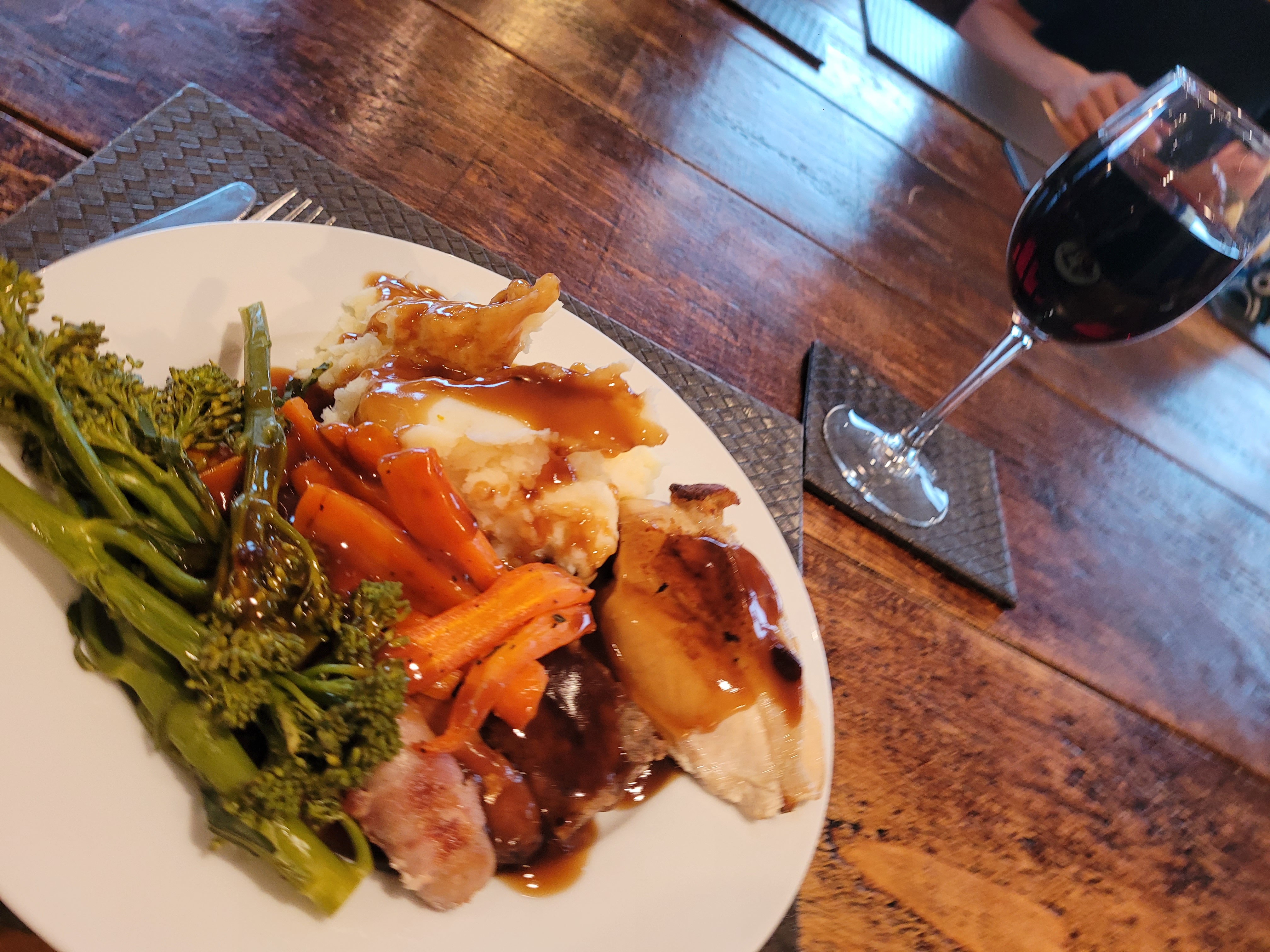 Chicken roast dinner and glass of red wine